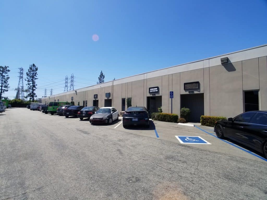 Unit frontages at the subject small-bay flex and industrial project on State Road, Cerritos, California, showing roll-up doors, pedestrian entries and shared surface parking.