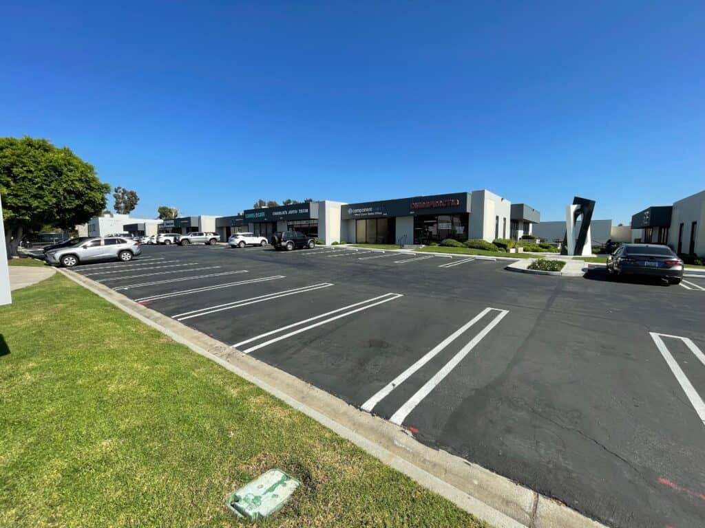 Commercial flex and industrial buildings in Orange County, California, with ample parking and clear blue skies — showcasing the region’s stable and modern commercial real estate market in 2025.