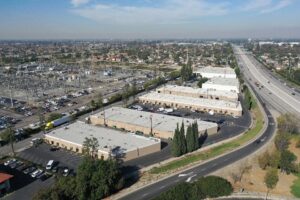 Aerial view of State Road Flex commercial property in Cerritos CA marketed by KEYZ Commercial featuring multiple flex buildings with freeway access