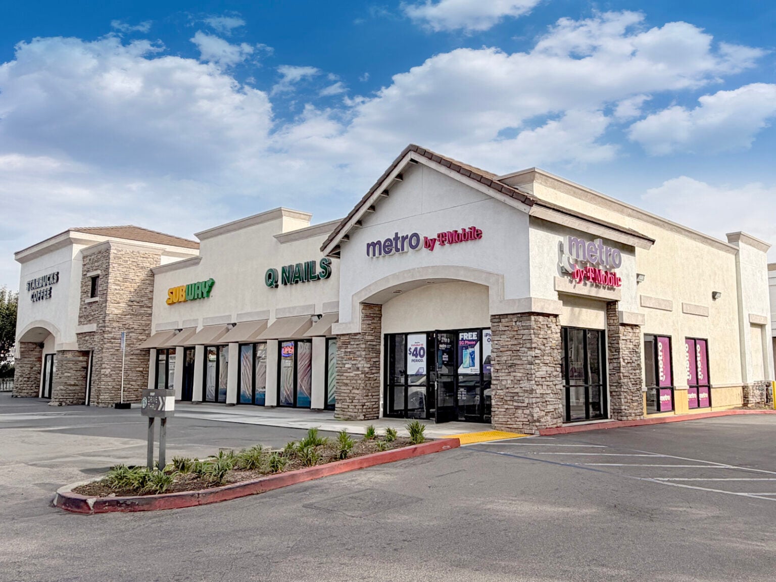 Storefront at Starbucks Centre on North Bristol Street, Santa Ana, stone-clad columns and glazed shopfronts under a tile roof
